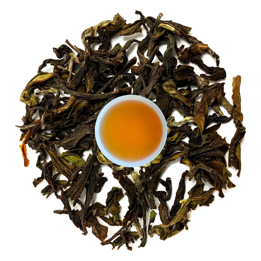 27 Himalayas Best Oolong Tea leaves surrounding a cup of brewed tea, showcasing its smooth, aromatic qualities.