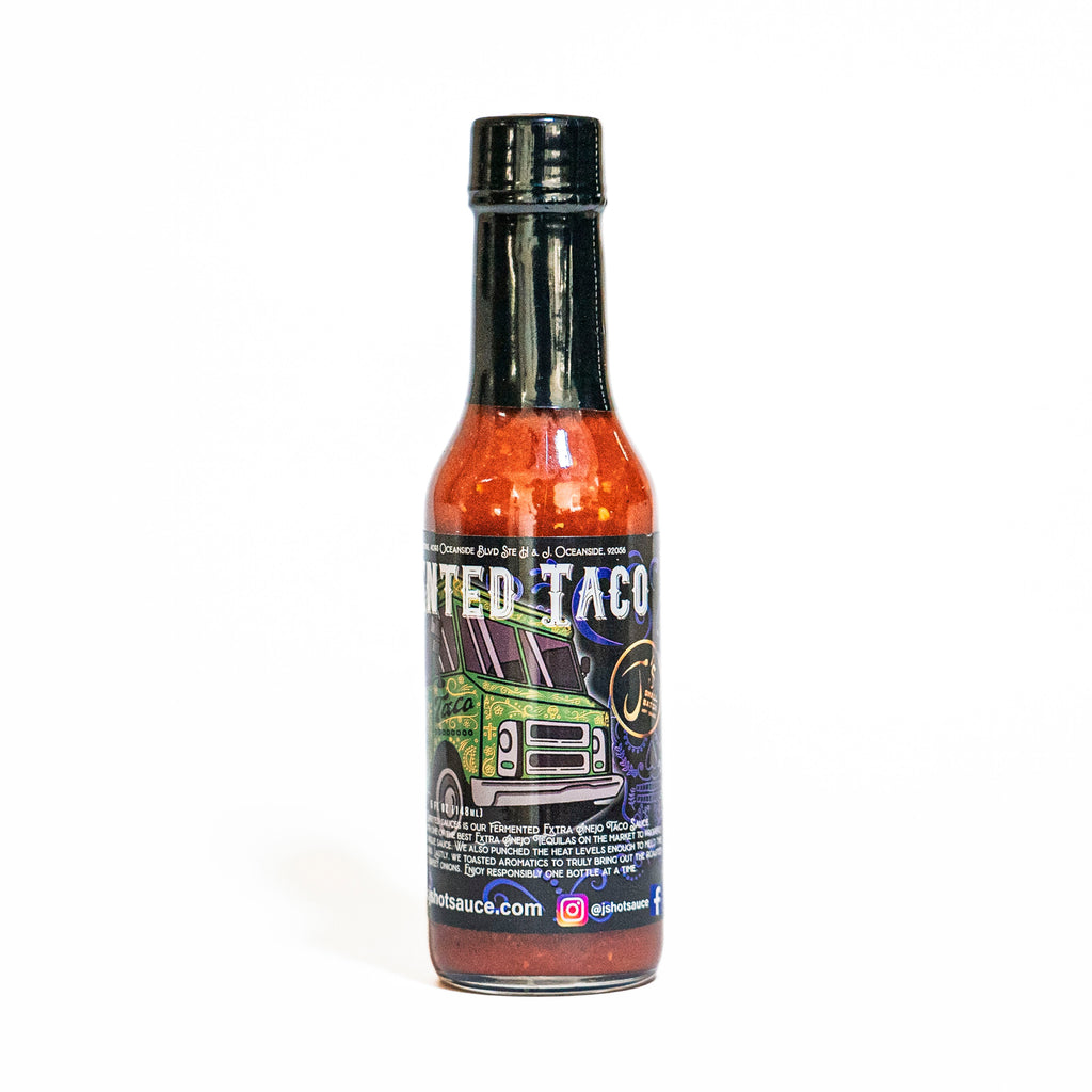 Hot sauce bottle with colorful label on a white background