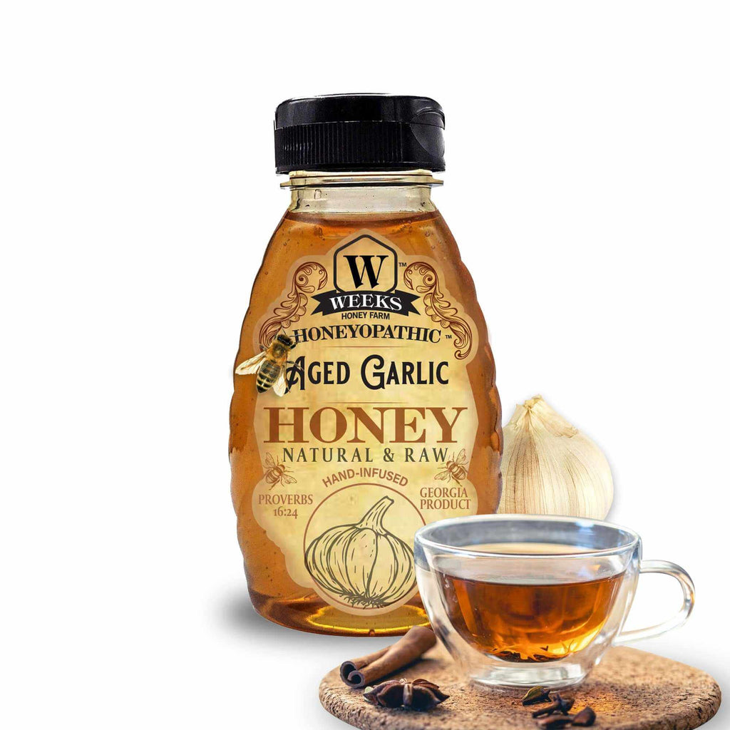 premium honey supplements from Weeks Honey Farm in a bottle with aged garlic and a cup beside it.